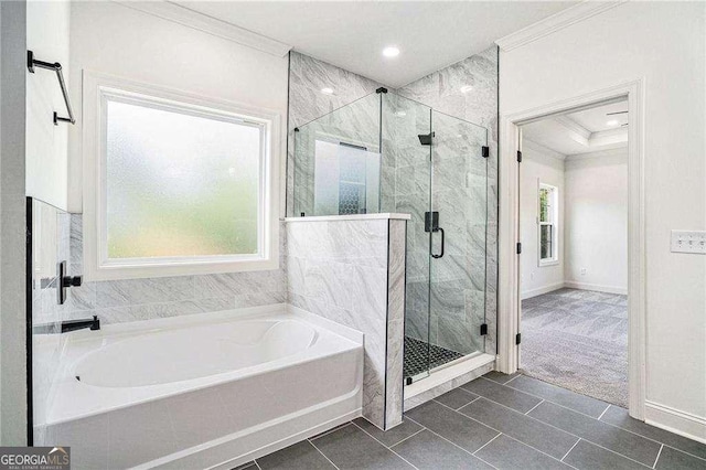 bathroom with tile patterned floors, independent shower and bath, and ornamental molding