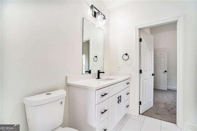 bathroom featuring tile patterned floors, vanity, and toilet