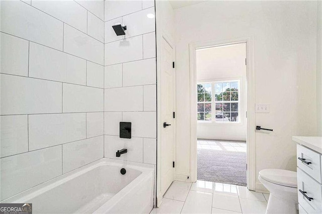 full bathroom featuring tile patterned floors, toilet, vanity, and tiled shower / bath