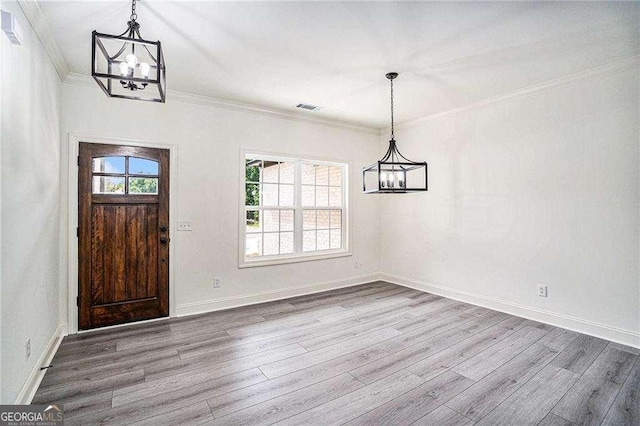 entrance foyer featuring hardwood / wood-style floors and crown molding