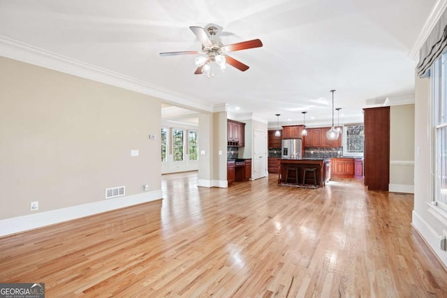 unfurnished living room featuring ceiling fan, light hardwood / wood-style floors, and ornamental molding