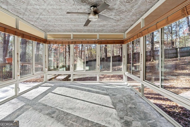 unfurnished sunroom featuring ceiling fan