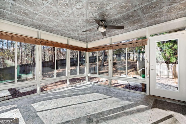 sunroom featuring ceiling fan