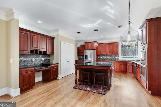 kitchen featuring stainless steel refrigerator with ice dispenser, light wood-type flooring, a kitchen breakfast bar, pendant lighting, and a kitchen island