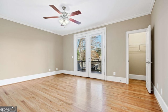 empty room with ceiling fan, ornamental molding, french doors, and light hardwood / wood-style flooring