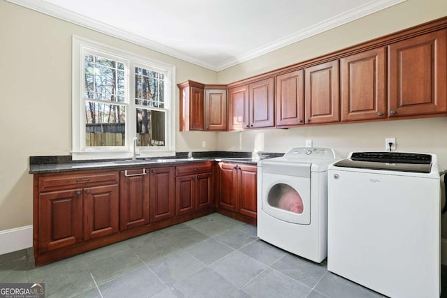 laundry area featuring sink, ornamental molding, cabinets, and independent washer and dryer