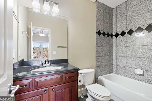 full bathroom featuring vanity, toilet, ceiling fan, and tiled shower / bath combo