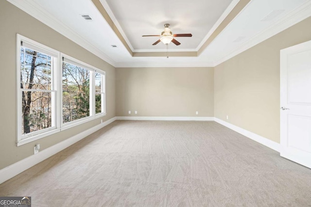 unfurnished room with carpet, a tray ceiling, ceiling fan, and ornamental molding