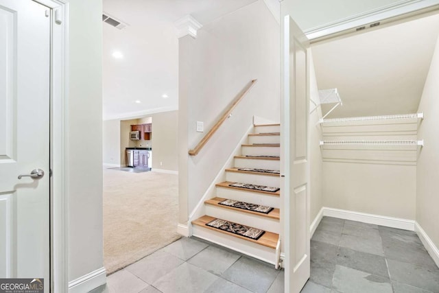 staircase with carpet flooring and crown molding