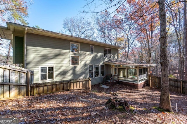 back of house featuring a sunroom