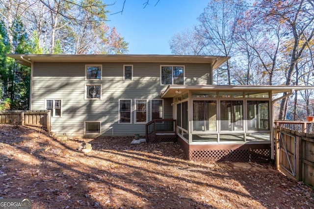 rear view of property with a sunroom