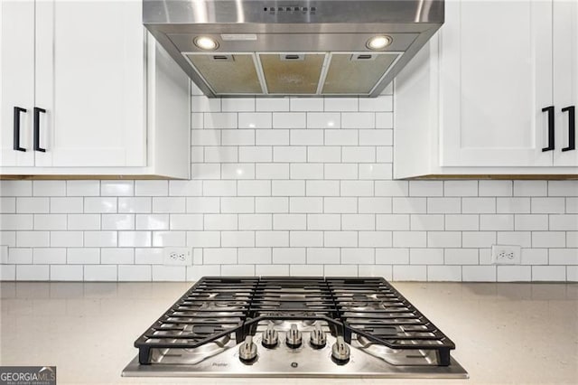 kitchen featuring tasteful backsplash, white cabinetry, and exhaust hood