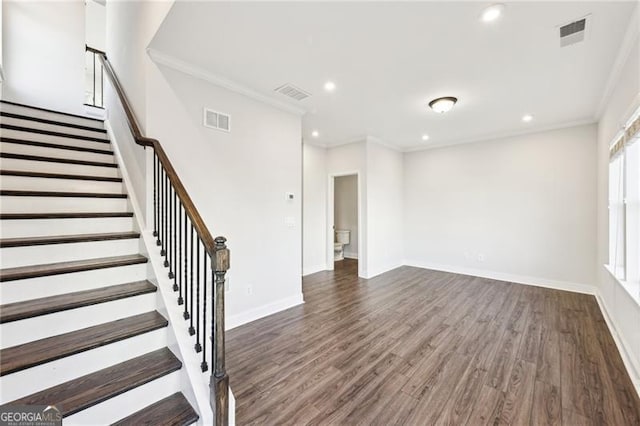 interior space with crown molding and dark wood-type flooring