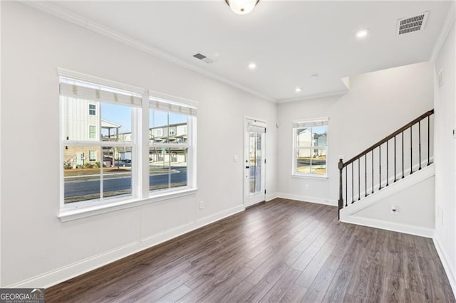 foyer entrance featuring dark wood-type flooring and ornamental molding