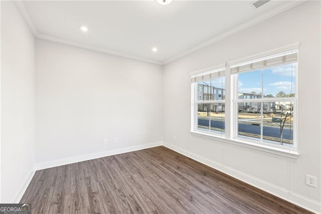 spare room with crown molding and wood-type flooring