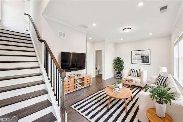 living room with dark hardwood / wood-style flooring and ornamental molding