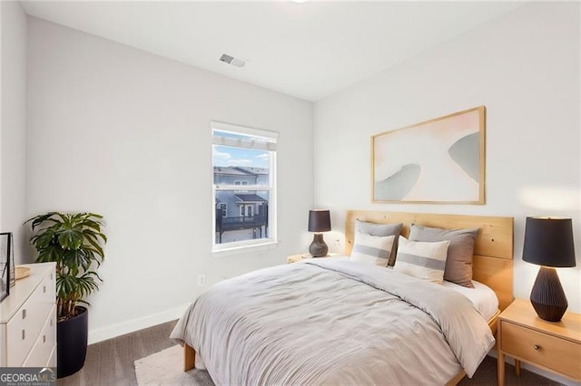 bedroom with dark hardwood / wood-style floors