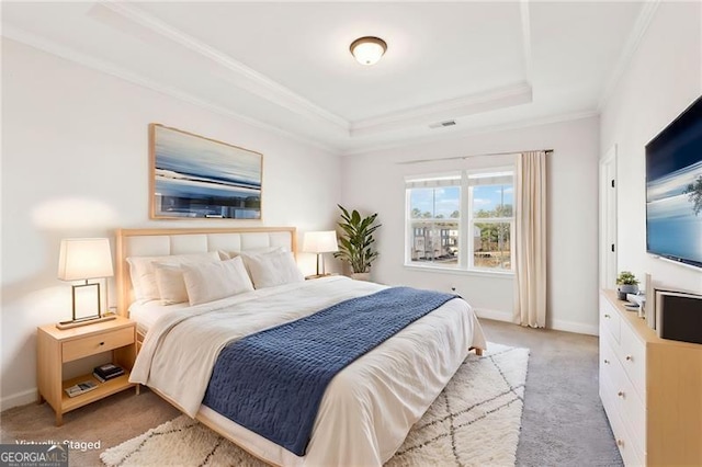 bedroom with crown molding, a raised ceiling, and light carpet