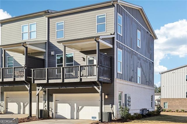 rear view of property featuring cooling unit and a garage