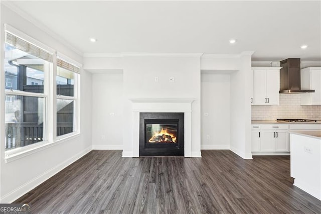 unfurnished living room featuring crown molding and dark hardwood / wood-style floors