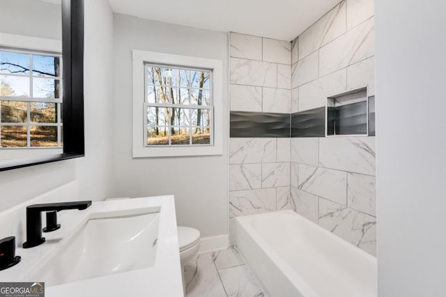 full bathroom with tiled shower / bath combo, toilet, and sink