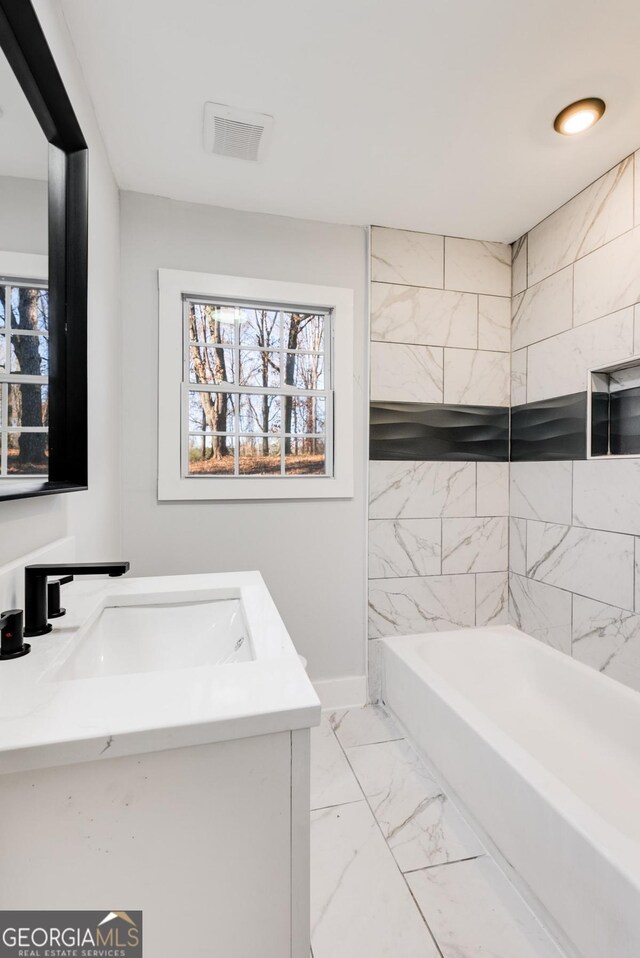 bathroom featuring vanity and a bathtub