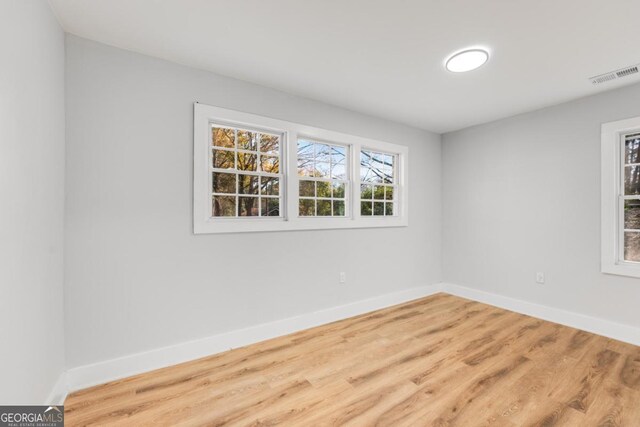 spare room with hardwood / wood-style floors