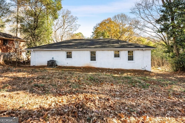 back of house with central air condition unit