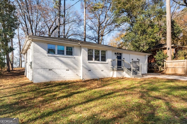 rear view of property with a lawn