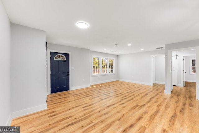 unfurnished living room featuring light hardwood / wood-style flooring