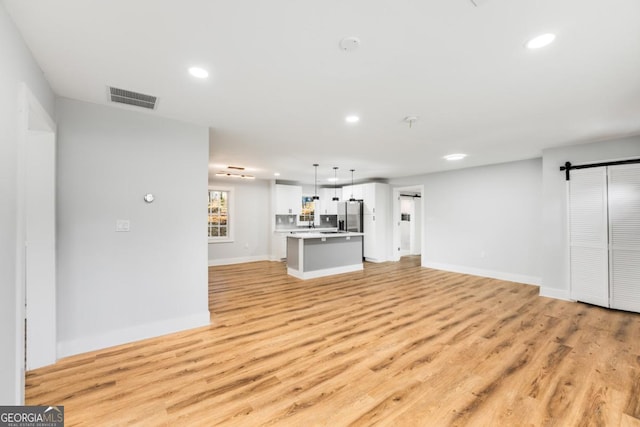 unfurnished living room featuring light wood-type flooring