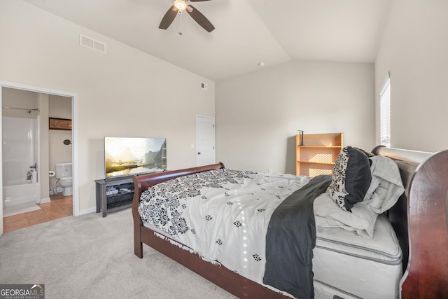 carpeted bedroom with ceiling fan, connected bathroom, and vaulted ceiling