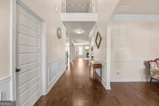 corridor featuring dark hardwood / wood-style flooring and ornamental molding