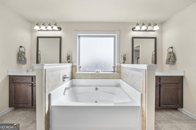 bathroom featuring tile patterned flooring, vanity, and a tub to relax in