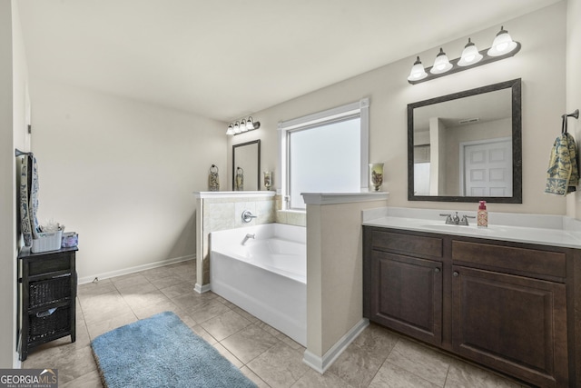 bathroom with a washtub and vanity