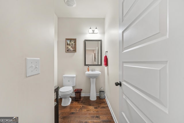 bathroom featuring sink, wood-type flooring, and toilet