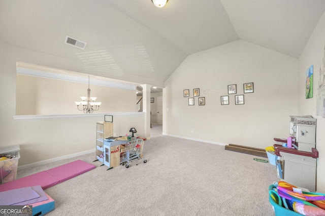 recreation room featuring carpet flooring, vaulted ceiling, and an inviting chandelier