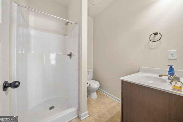 bathroom featuring vanity, toilet, and walk in shower