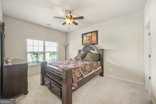 bedroom with ceiling fan and light carpet