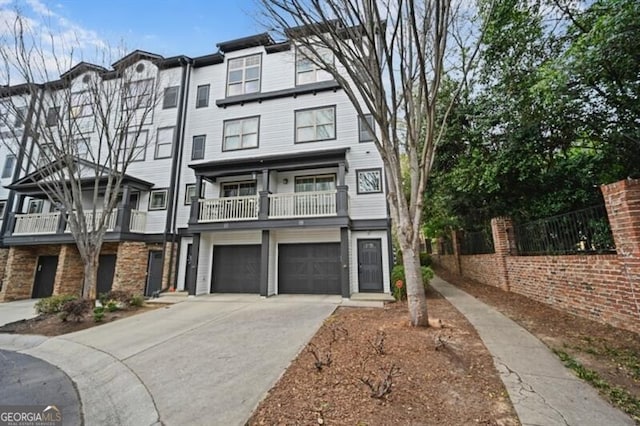 multi unit property with a balcony and a garage