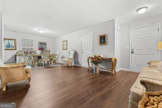 living room featuring dark hardwood / wood-style floors and a textured ceiling