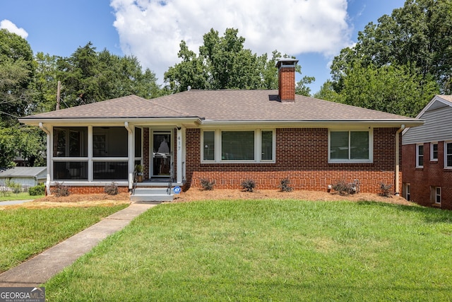 ranch-style home with a sunroom and a front yard