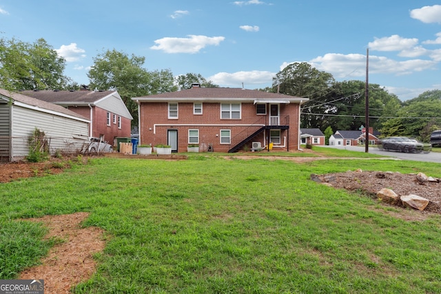 back of property with a lawn