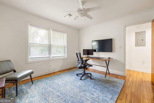 office space with hardwood / wood-style floors, ceiling fan, crown molding, and electric panel