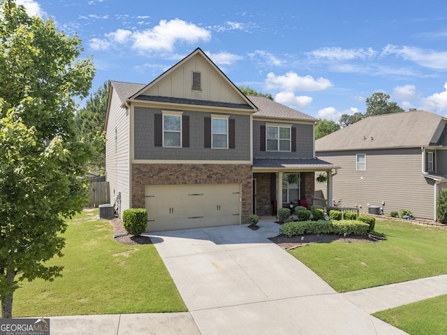 view of front facade with a front yard, a garage, and central AC unit