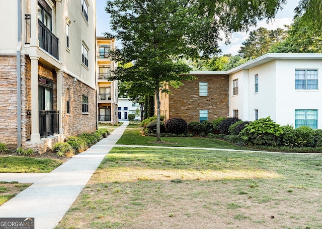 view of home's community with a yard