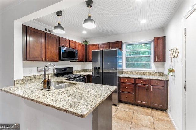 kitchen with kitchen peninsula, appliances with stainless steel finishes, pendant lighting, and sink