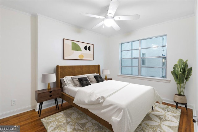 bedroom featuring crown molding, ceiling fan, and dark wood-type flooring