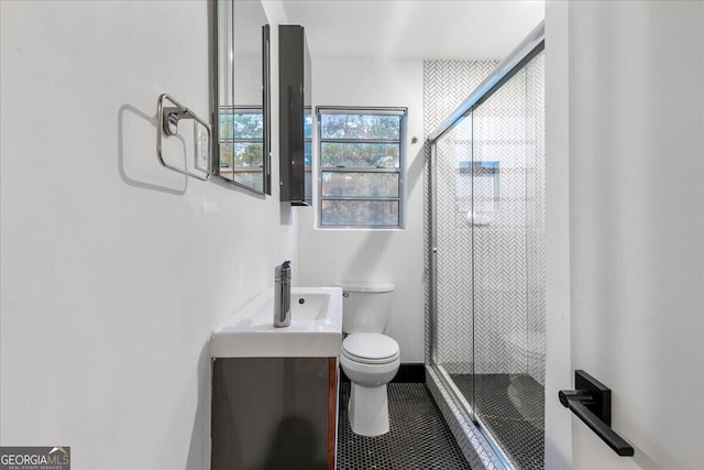 bathroom with an enclosed shower, vanity, and toilet