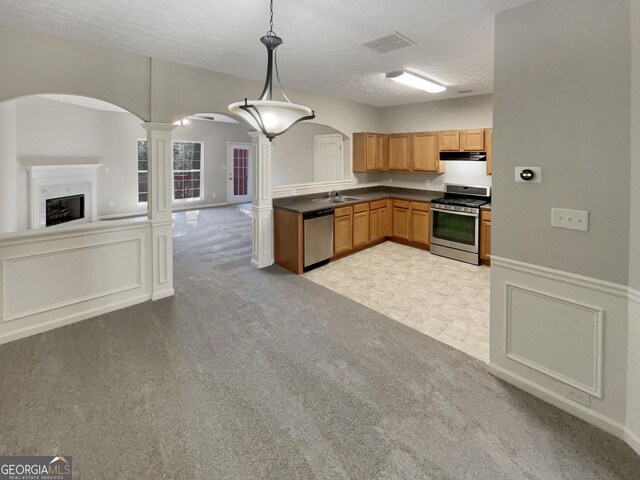 kitchen featuring light carpet, decorative columns, a textured ceiling, stainless steel appliances, and pendant lighting